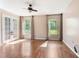 Spacious living room with wood-look floors, french doors, and many windows at 10423 Manassas Cir, Orlando, FL 32821