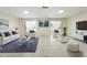 Bright living room with tiled floor, white furniture, area rug, and french doors that lead to a balcony at 10423 Manassas Cir, Orlando, FL 32821