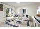 Bright living room with an L-shaped couch, plush rug, and a modern coffee table at 10423 Manassas Cir, Orlando, FL 32821