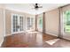 Bright living room features wood-look floors, french doors, and large windows at 10423 Manassas Cir, Orlando, FL 32821