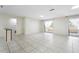 Bright living room features sliding glass doors, ceramic tile flooring, and neutral walls at 10423 Manassas Cir, Orlando, FL 32821