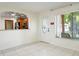 Bright, open living space with tiled floors features an arched opening to the kitchen and a view of the front yard at 10423 Manassas Cir, Orlando, FL 32821