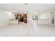 Expansive open-concept living space with tiled floors, showcasing the kitchen, dining, and living areas together at 10423 Manassas Cir, Orlando, FL 32821