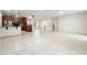 Open-concept living space with tiled floors, seamlessly connecting the kitchen to the bright living area at 10423 Manassas Cir, Orlando, FL 32821
