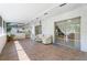 Spacious, covered patio with tile flooring, comfortable seating, and sliding glass doors at 10423 Manassas Cir, Orlando, FL 32821