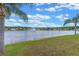 Backyard view of the lake with fountain and tropical landscaping provides serene views at 10435 Eastpark Lake Dr, Orlando, FL 32832