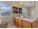 Bathroom featuring a double vanity with granite countertops and ample natural light at 10435 Eastpark Lake Dr, Orlando, FL 32832