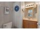 Well-lit half bath with a modern vanity and stylish decorative details at 10435 Eastpark Lake Dr, Orlando, FL 32832