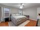 Bright bedroom with hardwood floors, a ceiling fan, and large windows at 10435 Eastpark Lake Dr, Orlando, FL 32832