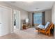 Guest bedroom with a futon, desk, and large window allowing natural light at 10435 Eastpark Lake Dr, Orlando, FL 32832