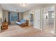 Bright bedroom with a futon, TV and a view to the bathroom and secondary bedroom at 10435 Eastpark Lake Dr, Orlando, FL 32832