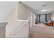 Upstairs hallway leading to the bedroom with a TV and futon in the background at 10435 Eastpark Lake Dr, Orlando, FL 32832