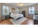 Cozy bedroom with hardwood floors, ample natural light, and neutral decor at 10435 Eastpark Lake Dr, Orlando, FL 32832