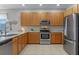 Spacious kitchen with stainless steel appliances, ample cabinetry, and granite countertops at 10435 Eastpark Lake Dr, Orlando, FL 32832