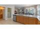Kitchen featuring an island with a sink, stainless steel appliances, and an adjacent living area at 10435 Eastpark Lake Dr, Orlando, FL 32832