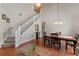 Well-lit living room and dining area, featuring a staircase and an open layout at 10435 Eastpark Lake Dr, Orlando, FL 32832