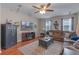 Living room with ceiling fan, hardwood floors, and decor elements at 10435 Eastpark Lake Dr, Orlando, FL 32832