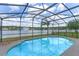 The private pool is enclosed by a screen, overlooking a tranquil lake at 10435 Eastpark Lake Dr, Orlando, FL 32832