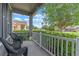 Inviting porch with seating area and view of the well-manicured front yard and neighborhood at 10435 Eastpark Lake Dr, Orlando, FL 32832