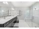 Modern bathroom with a glass-enclosed shower, dual vanity sinks, and built-in shelving at 1109 Castlevecchio Loop, Orlando, FL 32825