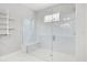 Modern bathroom features a glass-enclosed shower, marble tile, and built-in shelving at 1109 Castlevecchio Loop, Orlando, FL 32825