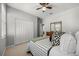 Bedroom with closet, dresser, bed with patterned bedding and mirror at 1109 Castlevecchio Loop, Orlando, FL 32825