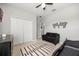 This bedroom has a race car bed, grey love seat, white closet, and checker flag art at 1109 Castlevecchio Loop, Orlando, FL 32825