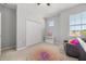 Bright bedroom with closet, window with a view, and seat under the window at 1109 Castlevecchio Loop, Orlando, FL 32825