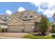 Charming two-story home with a brick driveway and a well-manicured lawn on a sunny day at 1109 Castlevecchio Loop, Orlando, FL 32825