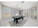 Bright game room features a pool table, modern lighting, and access to the outdoor patio at 1109 Castlevecchio Loop, Orlando, FL 32825