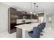 Modern kitchen featuring dark cabinets, stainless steel appliances, and a center island with bar seating at 1109 Castlevecchio Loop, Orlando, FL 32825