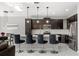 Bright kitchen featuring dark cabinets, stainless steel appliances, and a center island with bar seating at 1109 Castlevecchio Loop, Orlando, FL 32825