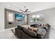 Cozy living room with a large sectional sofa, modern mirrors, ceiling fan, and plush rug at 1109 Castlevecchio Loop, Orlando, FL 32825