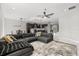 Spacious living room flowing into kitchen, features a large sectional sofa, plush rug, and modern decor at 1109 Castlevecchio Loop, Orlando, FL 32825