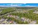 Aerial view of residential area marked by location pin surrounded by lush greenery and mature trees at 1117 Damask St, Celebration, FL 34747