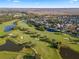 Expansive aerial view captures the lush golf course community, showcasing the winding fairways, serene ponds, and beautiful homes at 1117 Damask St, Celebration, FL 34747