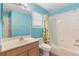Bright bathroom with tiled shower-tub, updated vanity, and a window, perfect for everyday use at 1117 Damask St, Celebration, FL 34747