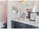 Bathroom featuring a double sink vanity, a large mirror, and a shower with a curtain at 1117 Damask St, Celebration, FL 34747