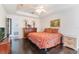 Bedroom featuring a tray ceiling, dark wood floors, and a view into the bathroom at 1117 Damask St, Celebration, FL 34747