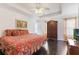 Bright bedroom with dark wood floors, a tray ceiling, and a window at 1117 Damask St, Celebration, FL 34747