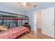 Sunlit bedroom featuring a bunk bed and a neutral palette, with a view of the hallway at 1117 Damask St, Celebration, FL 34747