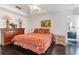 Spacious bedroom featuring a tray ceiling, dark wood floors, and a view into the bathroom at 1117 Damask St, Celebration, FL 34747
