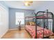 Bedroom with a modern bunk bed and ample natural light, perfect for a room at 1117 Damask St, Celebration, FL 34747