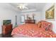 Bedroom featuring a tray ceiling, dark wood floors, and a view into another room at 1117 Damask St, Celebration, FL 34747