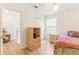Cozy bedroom featuring a side table, closet and ample storage space, with natural light at 1117 Damask St, Celebration, FL 34747