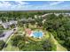 Aerial view of a community pool with palm trees, a fountain, and seating areas, surrounded by lush landscaping and homes at 1117 Damask St, Celebration, FL 34747