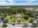 Aerial view of a community pool with lush landscaping, surrounded by palm trees and a circular walking path at 1117 Damask St, Celebration, FL 34747