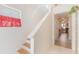 Hallway and stairs featuring a decorative window and an archway into another room at 1117 Damask St, Celebration, FL 34747