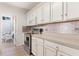 A well-lit kitchen with stainless steel appliances and sleek white cabinets at 1117 Damask St, Celebration, FL 34747
