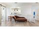 Cozy living room featuring a brown chaise lounge, hardwood floors, and an opening looking into the kitchen at 1117 Damask St, Celebration, FL 34747